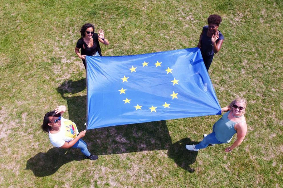 Four women holding an EU flag