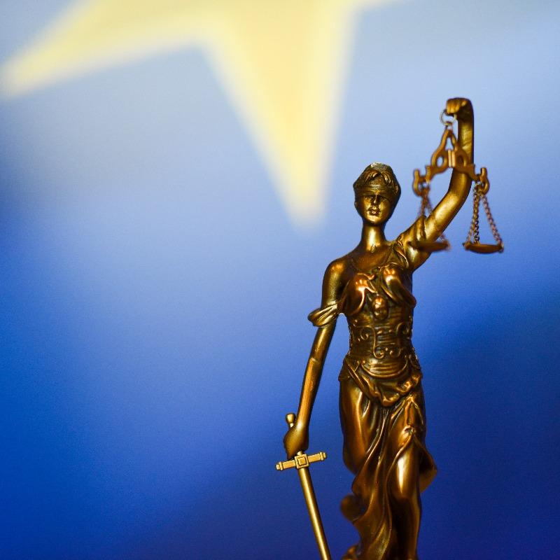 Symbolic image of justice with background of the EU flag