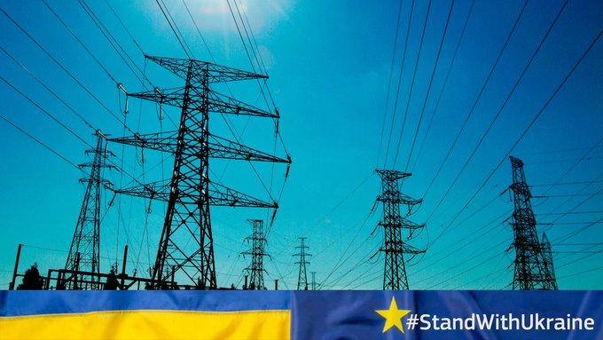 Image of power station with Ukrainian flag underneath and text: "Stand with Ukraine"