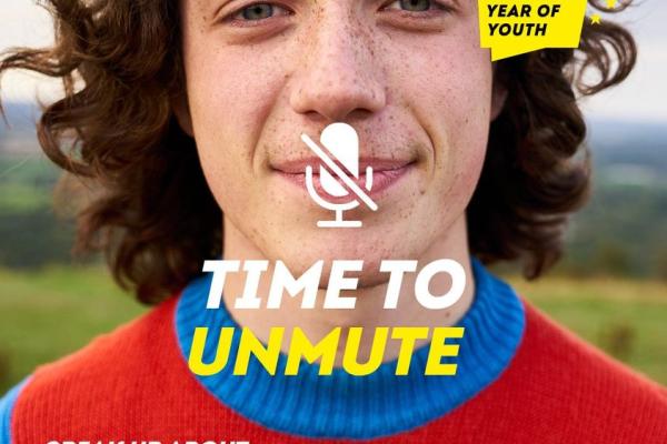 Image of young man with text "Time to unmute - speak up about the future of EU values. Visit youthvoices.eu"