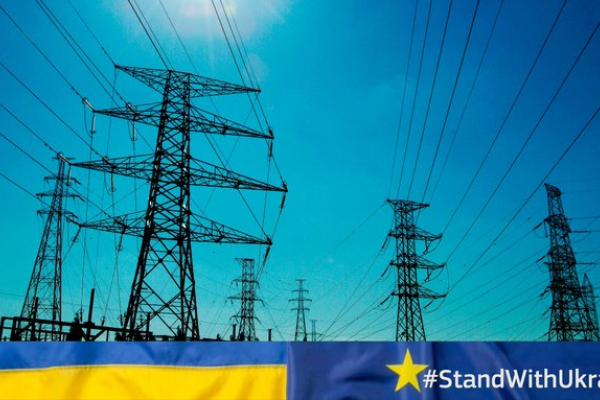 Image of power station with Ukrainian flag underneath and text: "Stand with Ukraine"