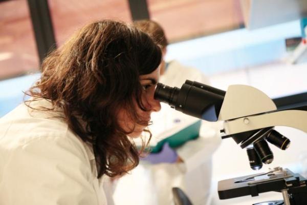 European Year of Skills - lab worker looking through microscope