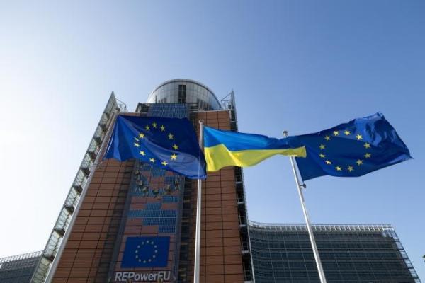 EU and Ukrainian flags raised side by side in front of the Berlaymont building in Brussels